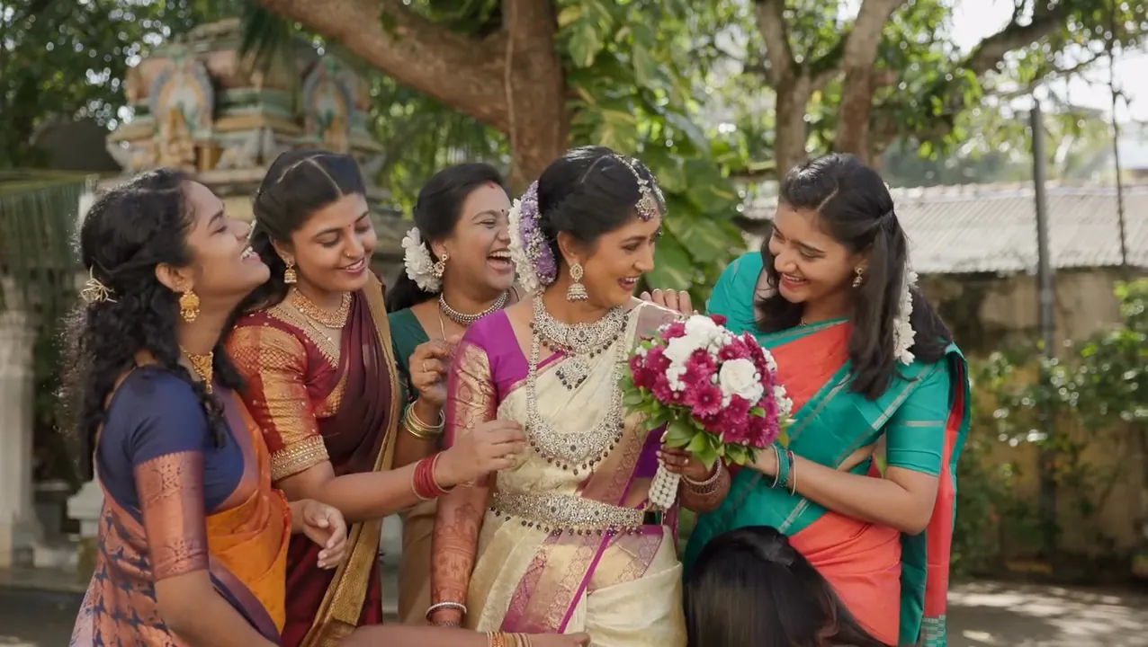 A bride laughing with her friends in the garden, unposed